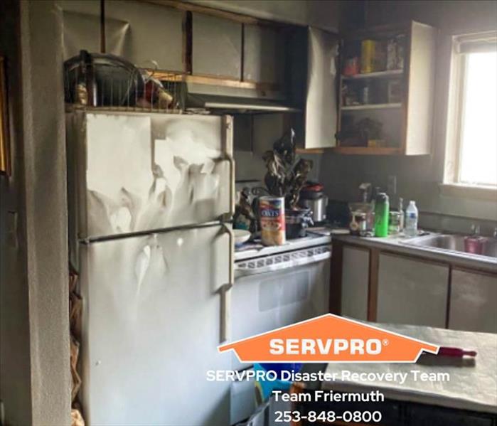 Kitchen fire damage with SERVPRO logo on image